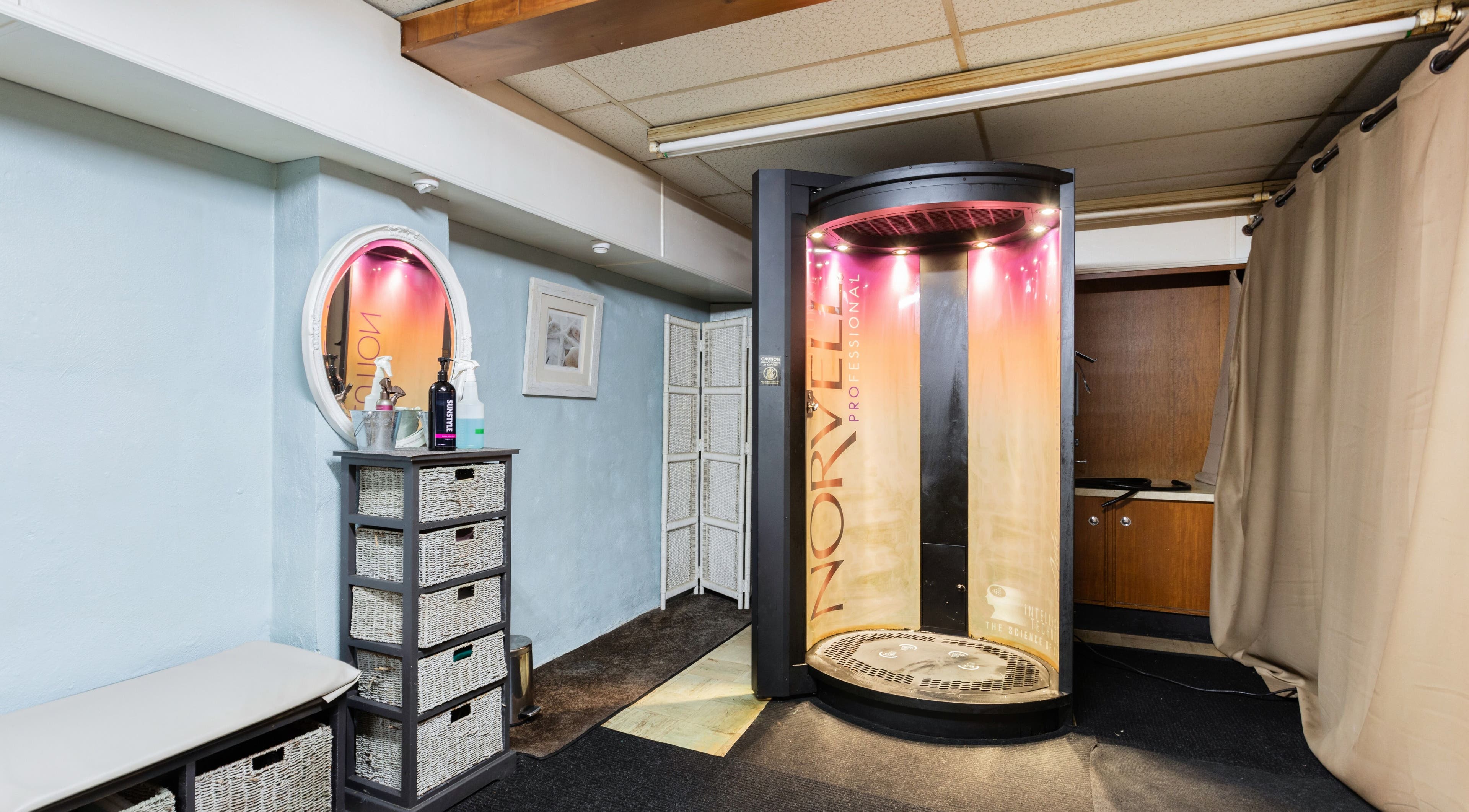 Tanning booth at Bare Beauty Aesthetics, Ludlow, Massachusetts, US, showcasing modern and inviting aesthetics.