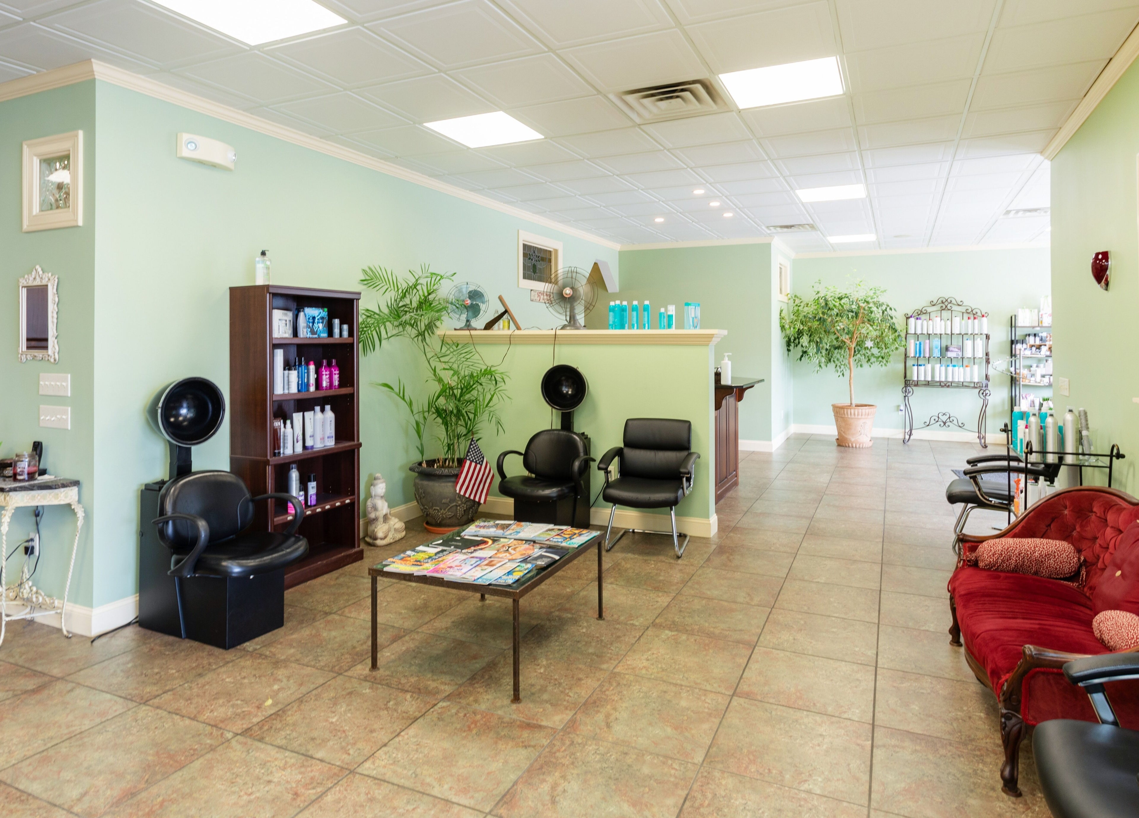 Spacious interior of Bare Beauty Aesthetics in Ludlow, Massachusetts, US showcasing seating, plants, and decor.
