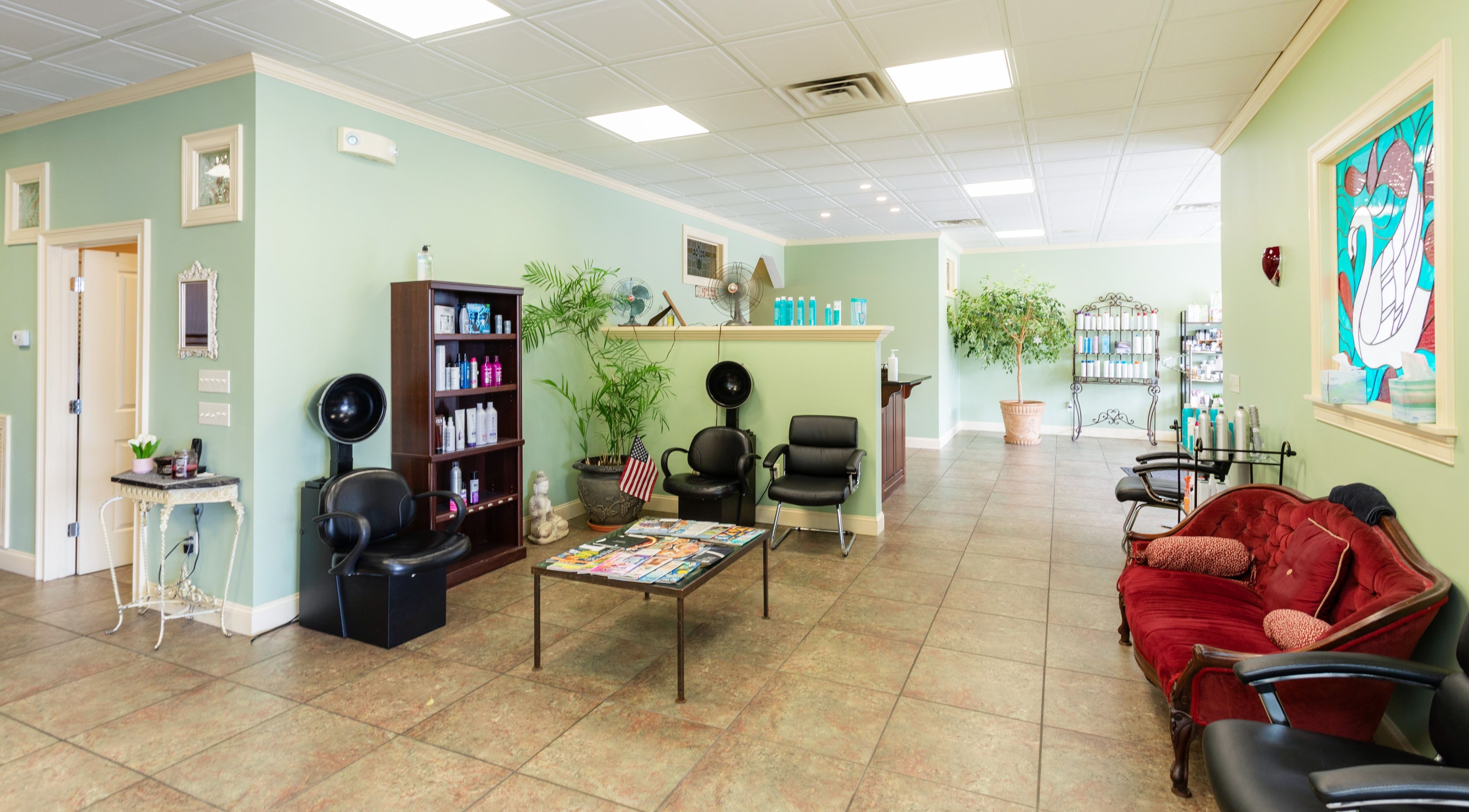 Spacious interior of Bare Beauty Aesthetics in Ludlow, Massachusetts, US showcasing seating, plants, and decor.