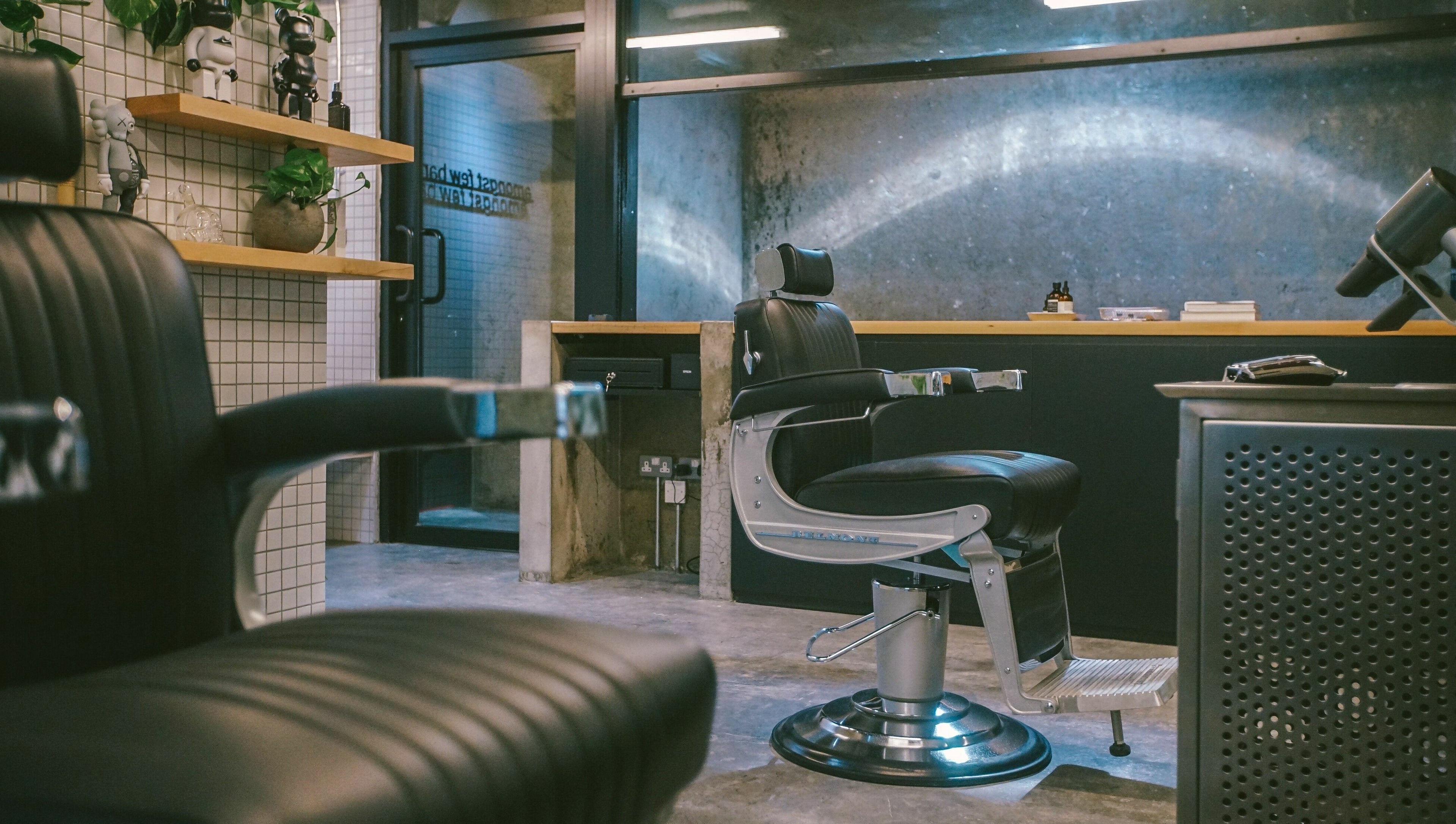Modern interior of Amongst Few Barber in دبي, دبي, AE with sleek black chairs and contemporary decor.