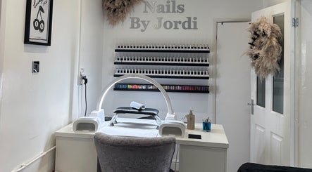 Nail treatment station at Jordi’s Hair and Beauty in Newhall, England, GB with manicure supplies and decor.