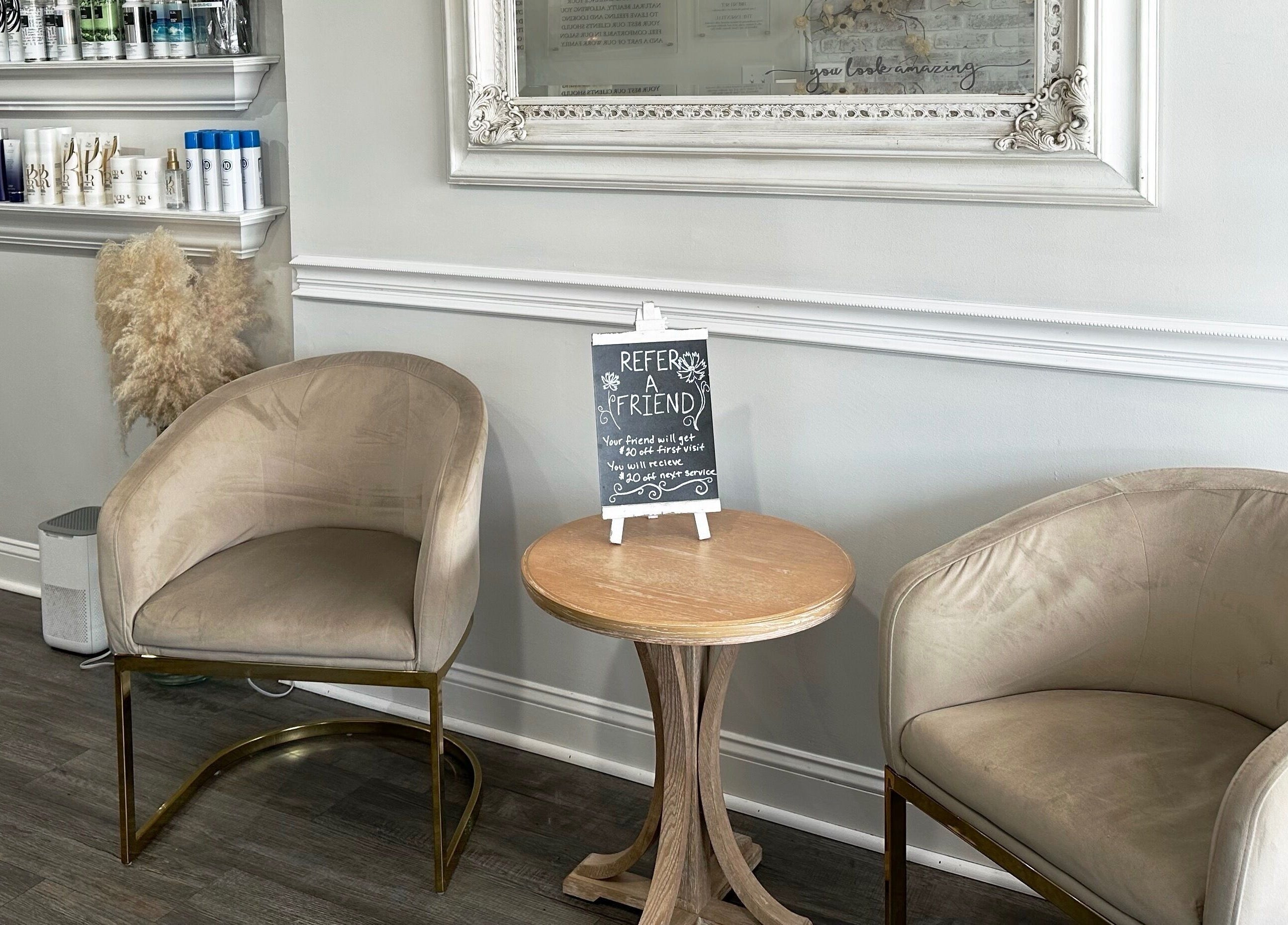 Inviting seating area at Bounce Hair Salon, Port Jefferson, New York, US with stylish chairs and product shelves.