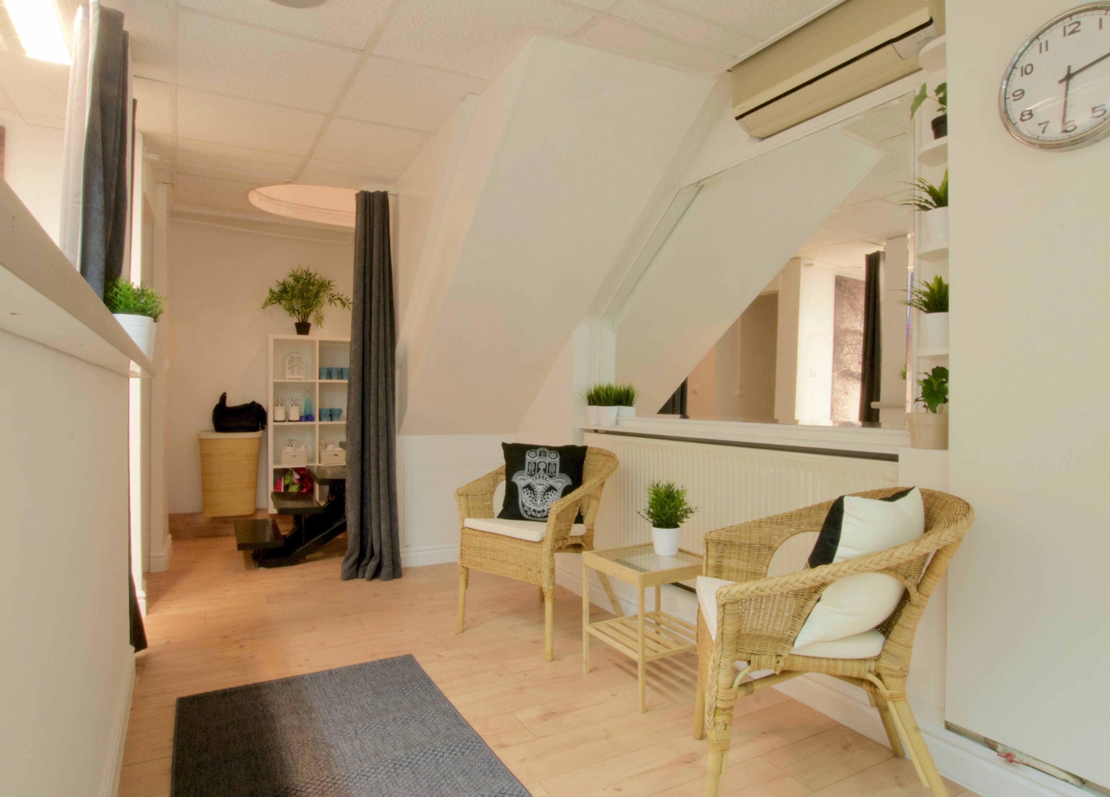 Calm seating area at Thai 5 Budapest Thai Massage, Budapest, Magyar, HU with wicker chairs and greenery.