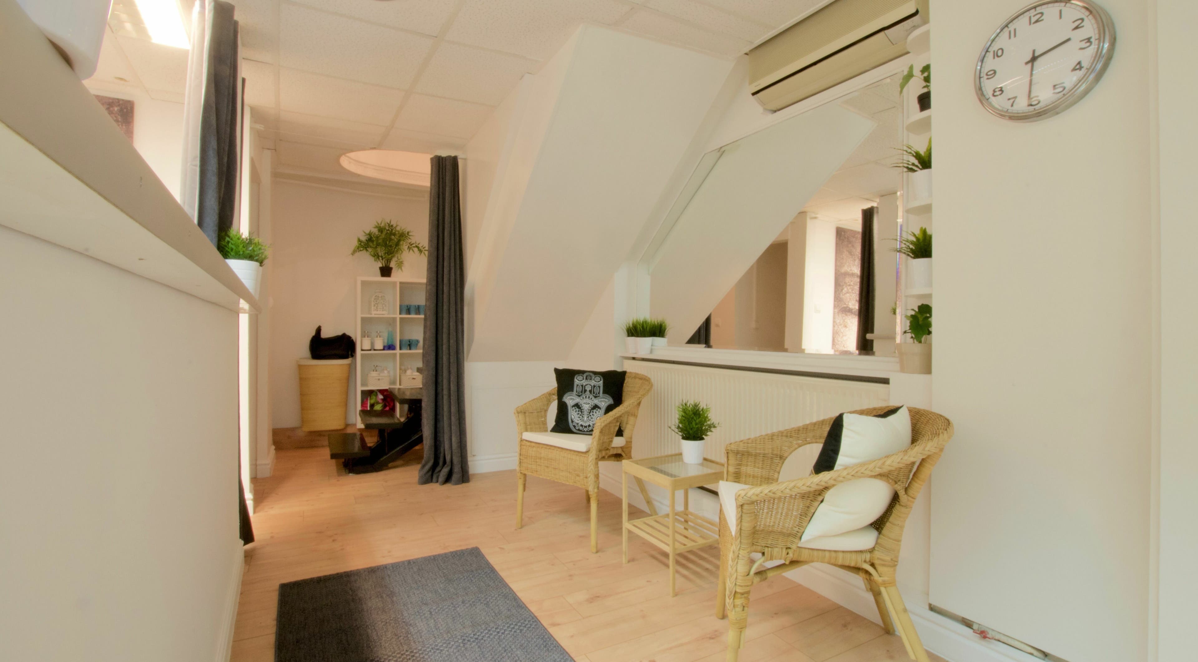 Calm seating area at Thai 5 Budapest Thai Massage, Budapest, Magyar, HU with wicker chairs and greenery.