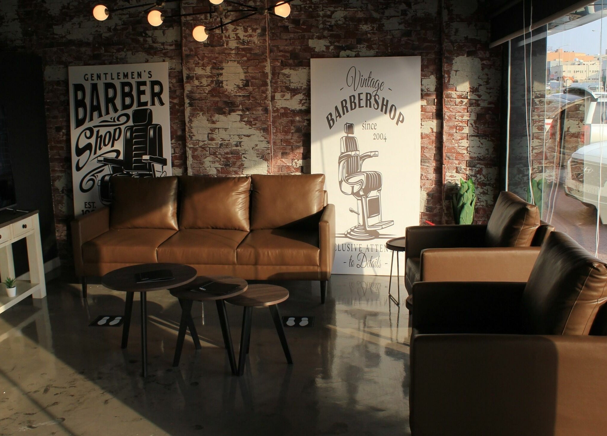 Cozy lounge area in 1993 BARBERSHOP featuring leather seats and vintage decor in Riyadh, Riyadh Province, SA.