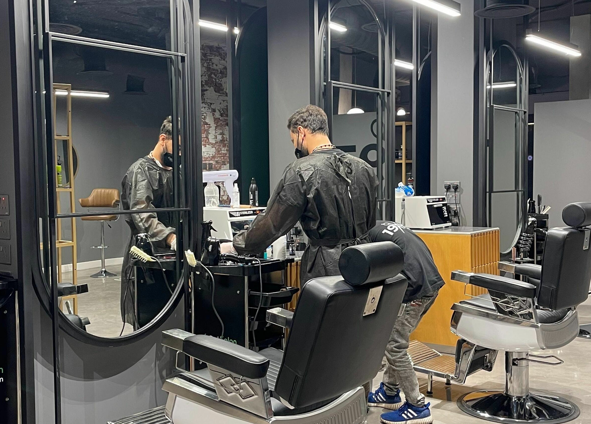 Inside view of 1993 BARBERSHOP in Riyadh, Riyadh Province, SA, featuring a barber preparing his station.