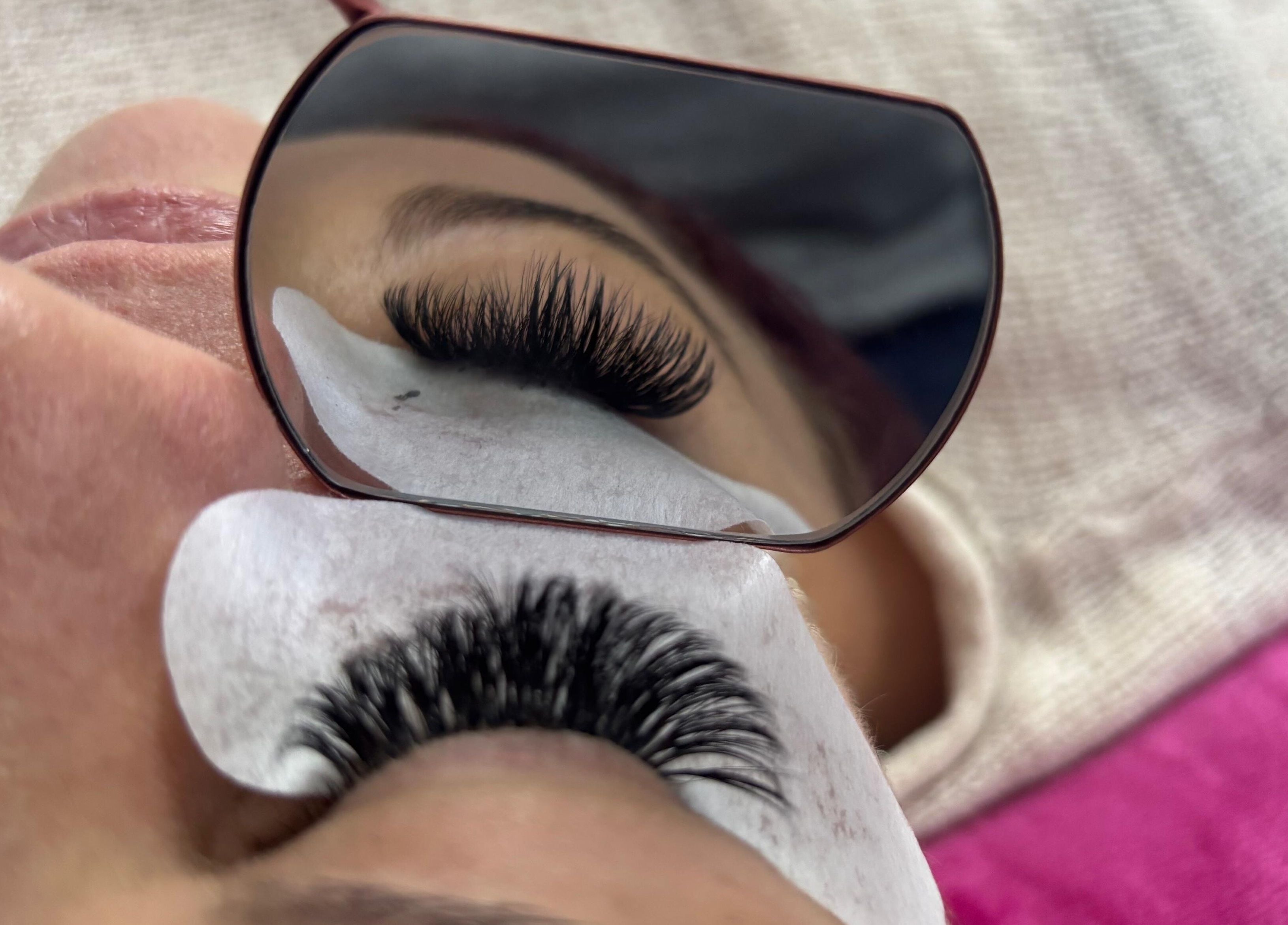 Close-up of eyelash extension application at Design on a Dime, Benoni, Gauteng, ZA, showcased in a mirror reflection.