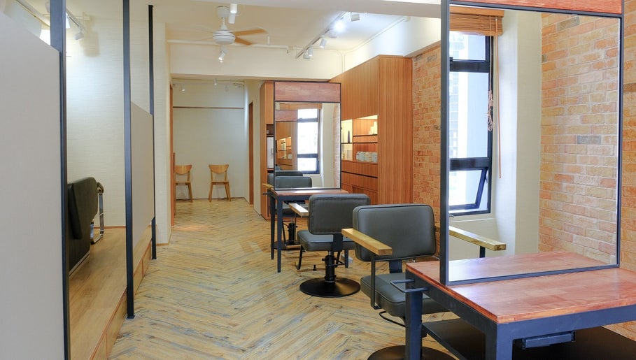 Stylish salon interior at Hair Quest, Hong Kong Island, HK. Features chic chairs and rustic decor.