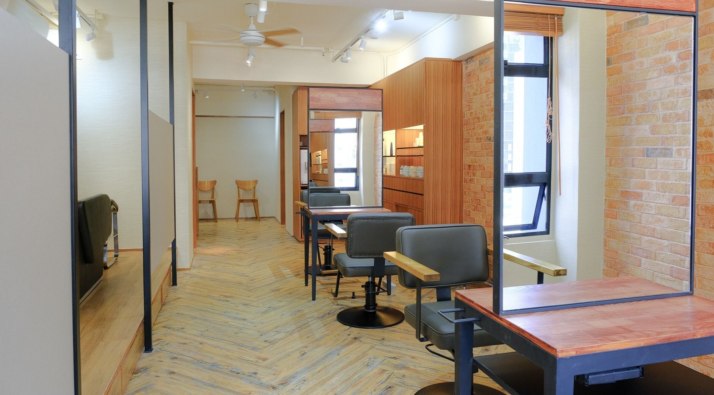 Stylish salon interior at Hair Quest, Hong Kong Island, HK. Features chic chairs and rustic decor.