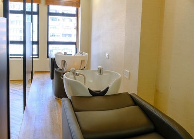 Modern wash stations at Hair Quest, Hong Kong Island, HK with bright natural light and comfortable seating.