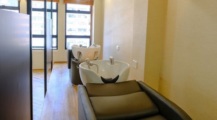 Modern wash stations at Hair Quest, Hong Kong Island, HK with bright natural light and comfortable seating.