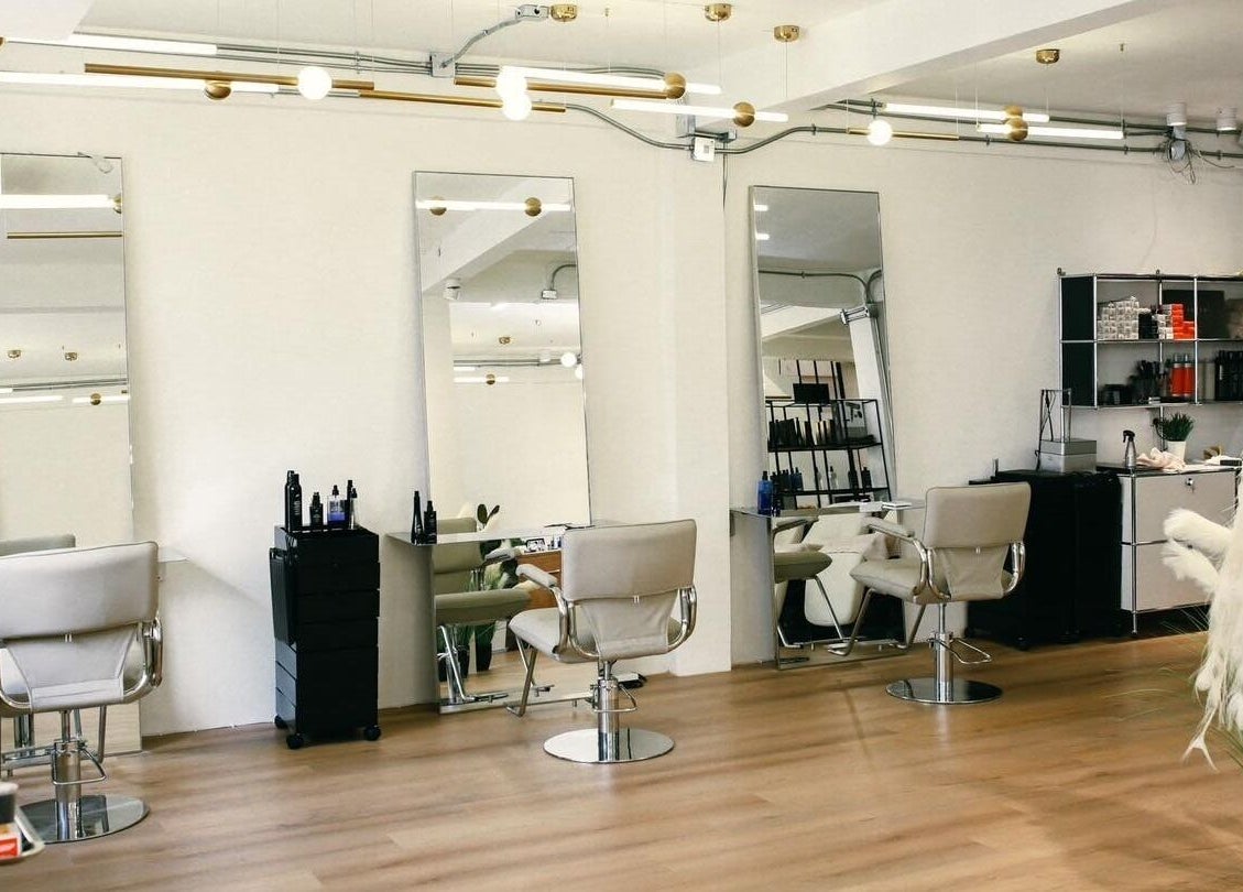 Interior of Lil Holistic Salon in Krung Thep Maha Nakhon, featuring modern chairs and mirrors.