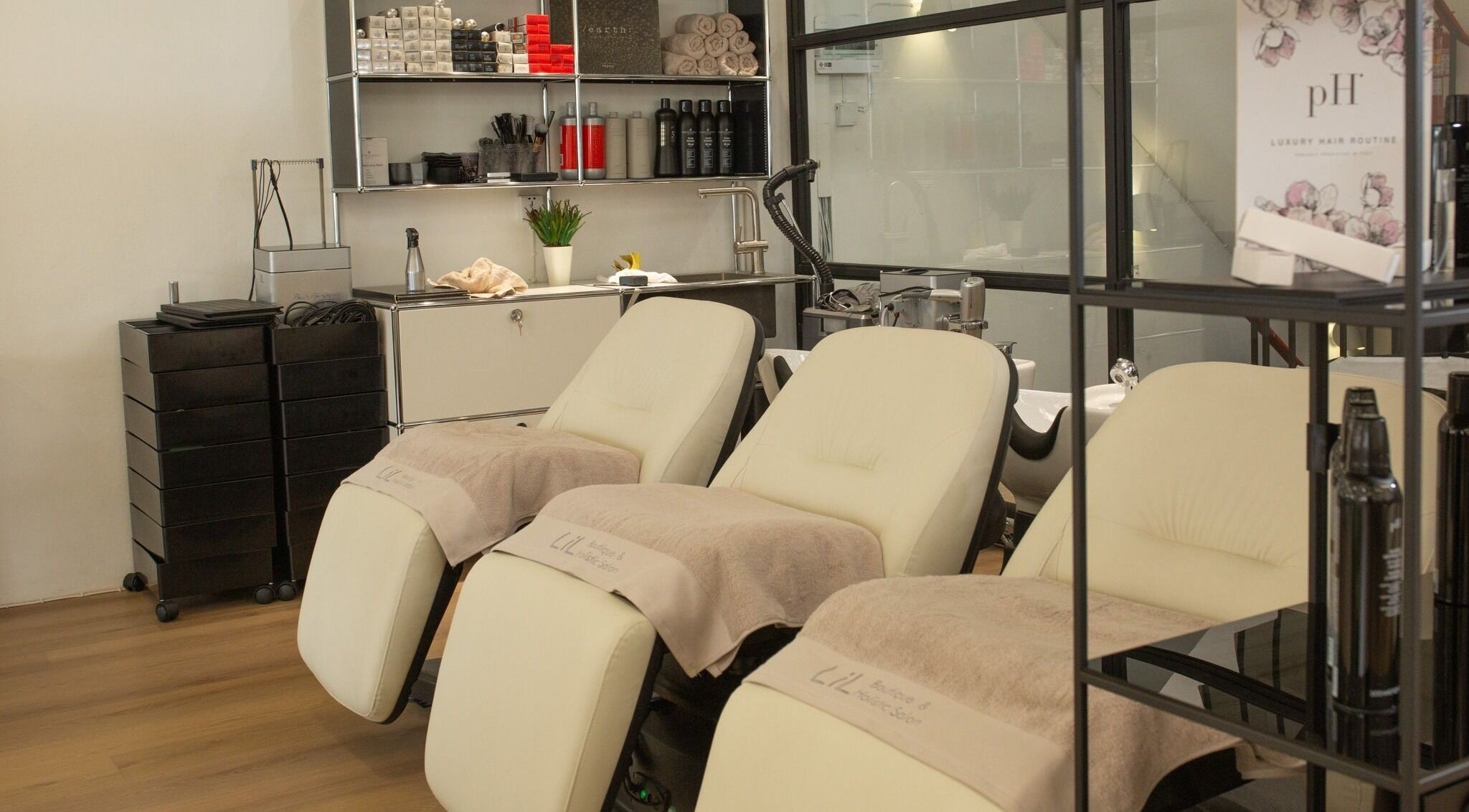 Cozy salon chairs at Lil Holistic Salon, Krung Thep Maha Nakhon, offering a relaxing beauty experience.