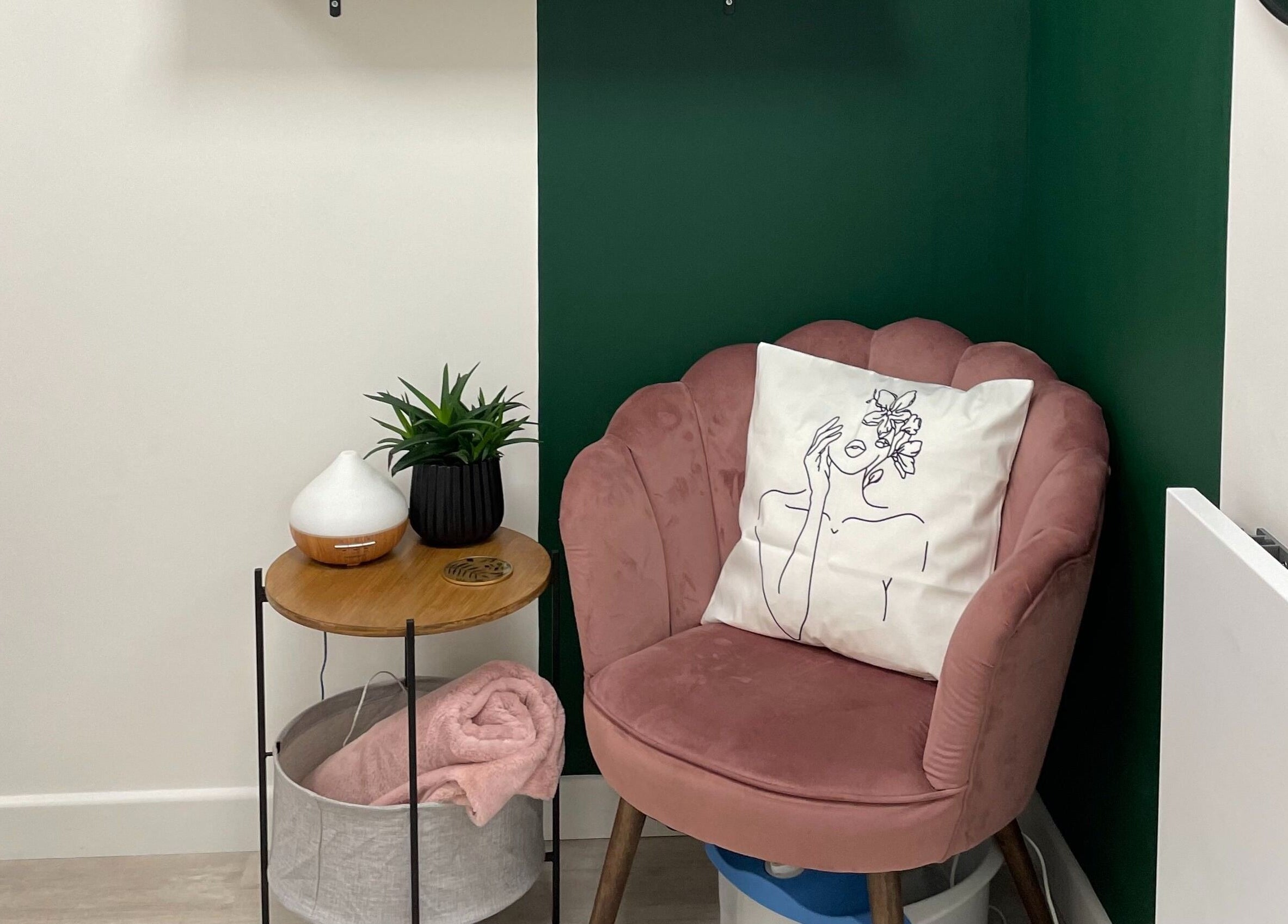 Cozy pink chair with floral cushion in KOA Beauty Lounge LTD, Crapstone, England, GB.
