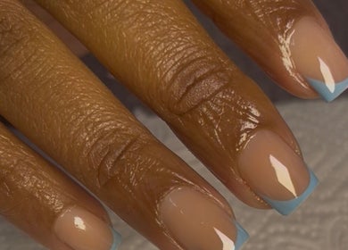 Chic blue French manicure at Ndawonde Beauty Boutique, Benoni, Gauteng, ZA, showcasing expert nail art.