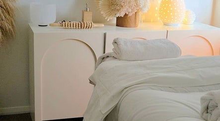 Elegant treatment room at Hills Holistic Spa, Gables, New South Wales, AU with ambient lighting and plush towels.
