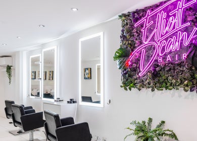 Modern salon interior at Elliott Dean in Romford, England, GB with stylish seating and vibrant decor.