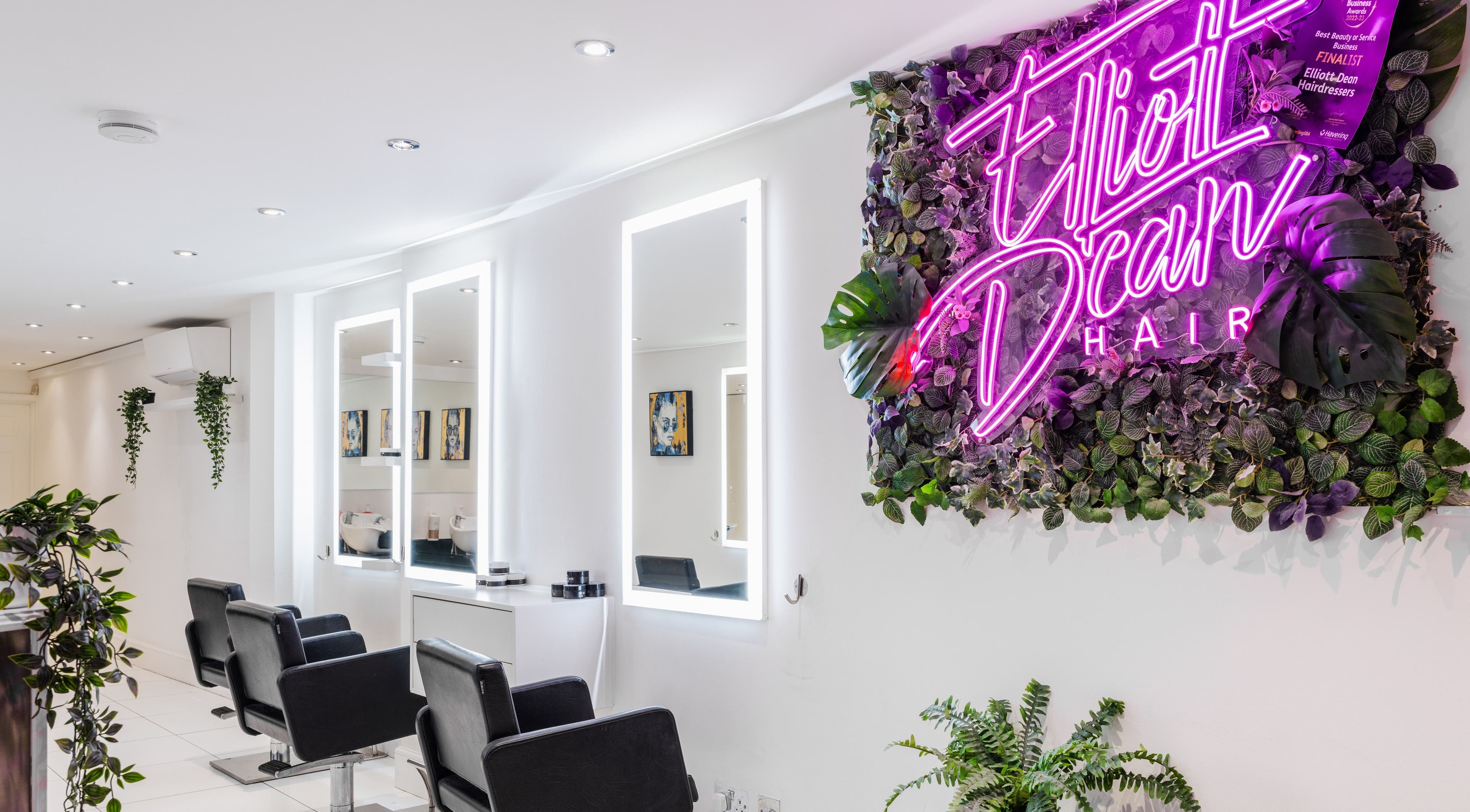 Modern salon interior at Elliott Dean in Romford, England, GB with stylish seating and vibrant decor.