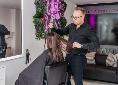 Professional hairstyle service at Elliott Dean in Romford, England. A stylist perfecting hair with care.