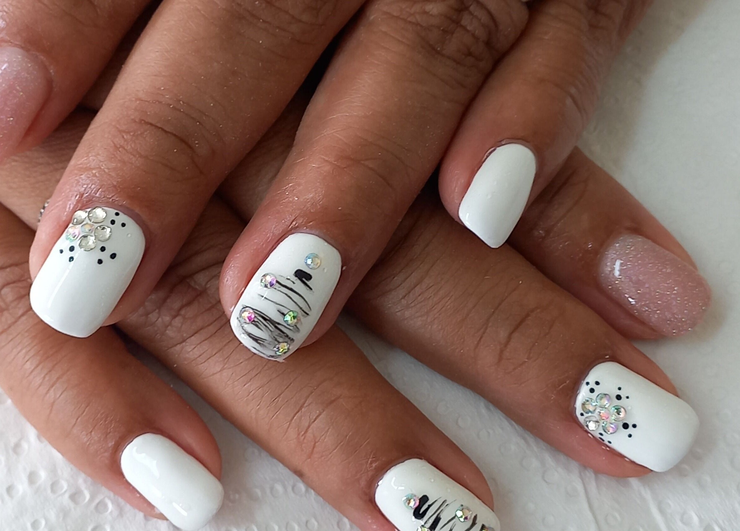 Elegant nail art at Mello's Mobile Beauty Spa, Gqeberha, Eastern Cape, ZA. White polish with jewel accents.