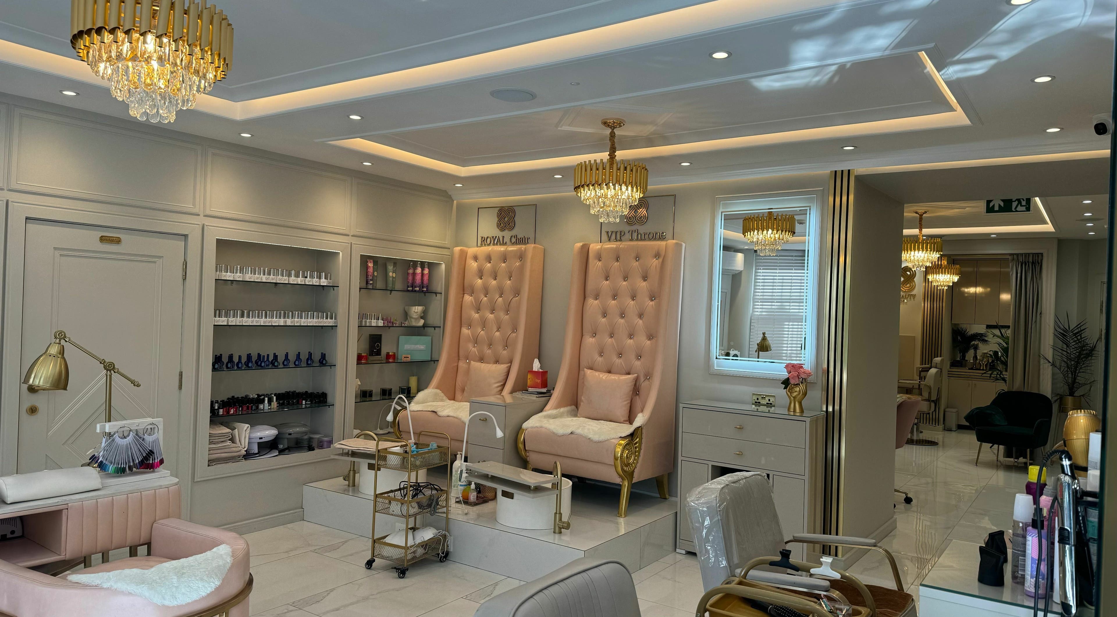 Luxurious interiors of L.Y. Beauty London in London, England, GB, featuring elegant golden decor and plush seating.