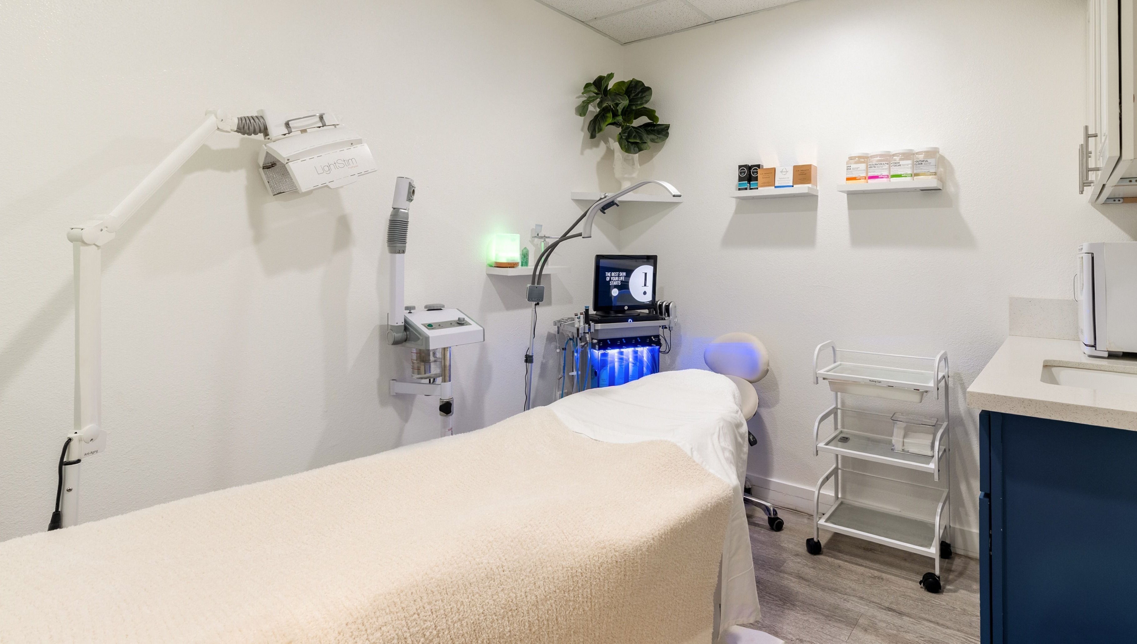 Calm treatment room at Just Be Skin Day Spa in Riverside, California, US, featuring advanced skincare equipment.