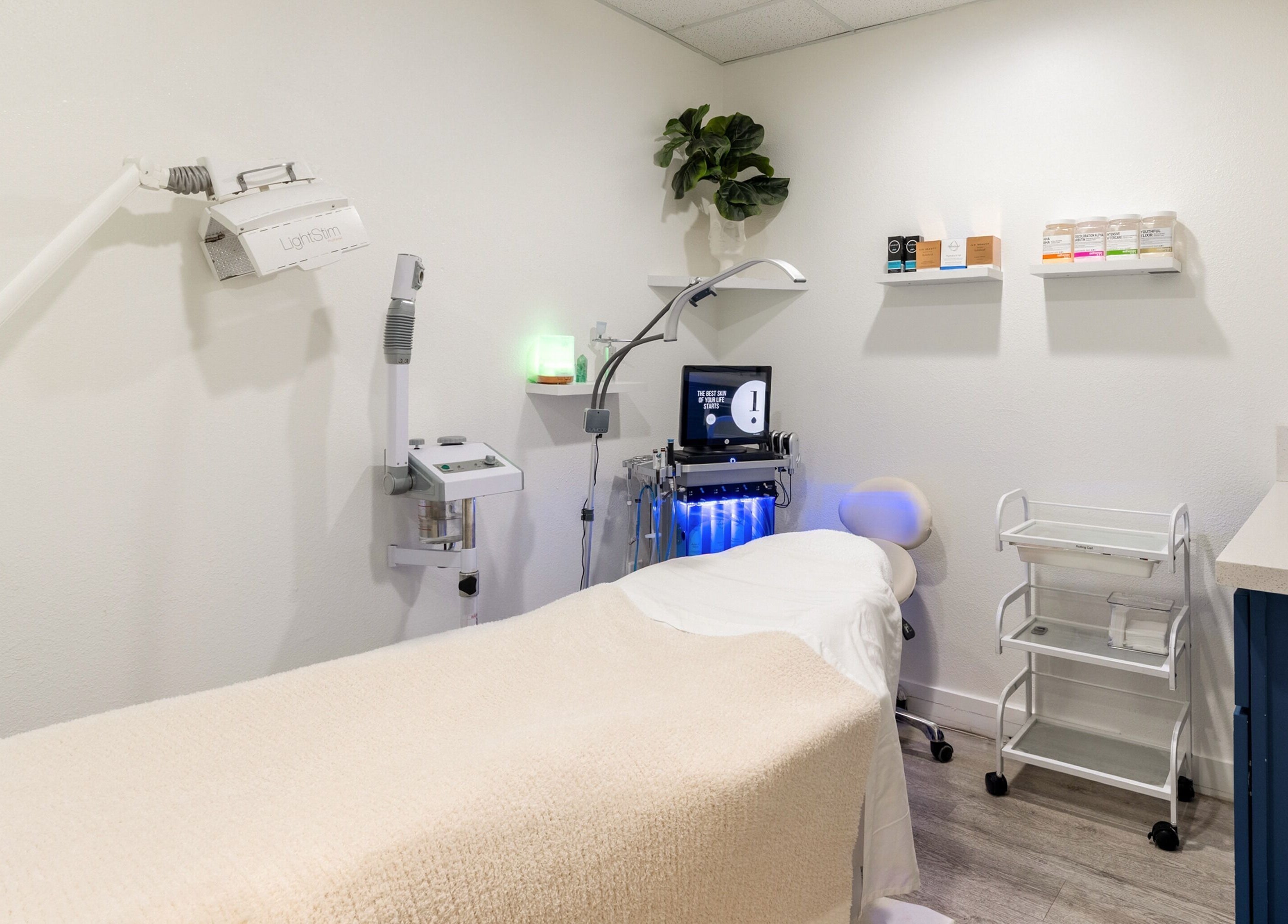 Calm treatment room at Just Be Skin Day Spa in Riverside, California, US, featuring advanced skincare equipment.