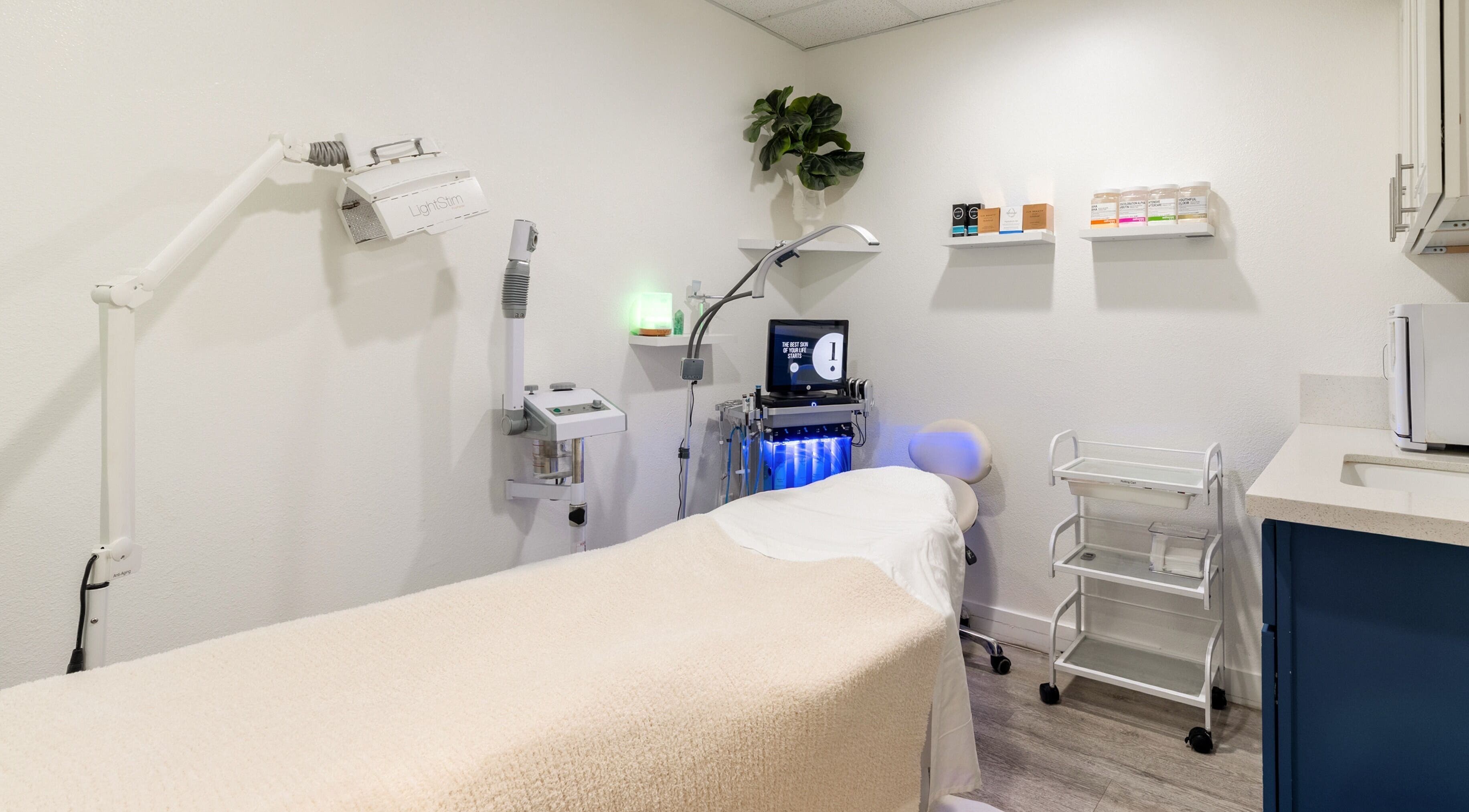 Calm treatment room at Just Be Skin Day Spa in Riverside, California, US, featuring advanced skincare equipment.