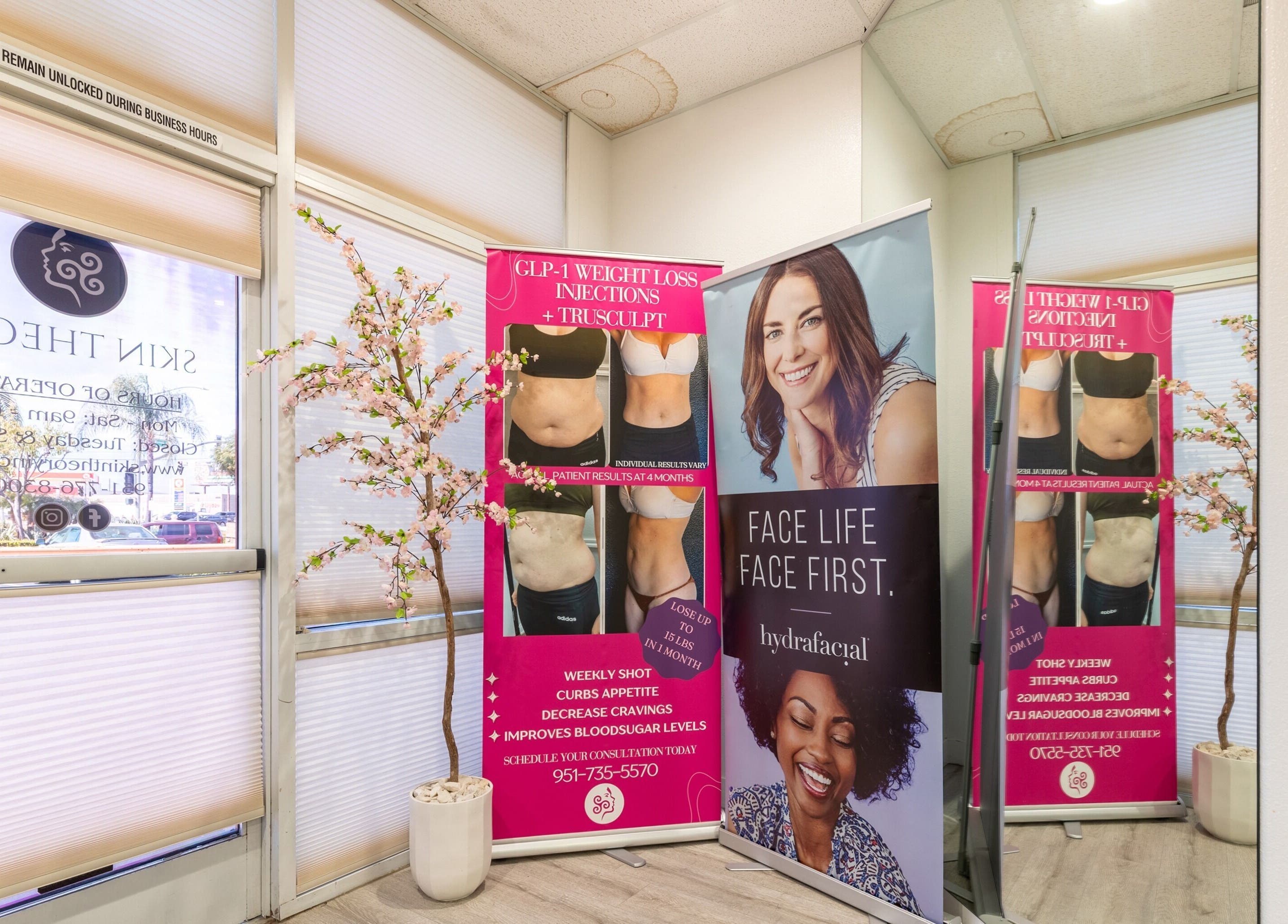 Promotional wellness banners inside Just Be Skin Day Spa in Riverside, California, US, showcasing treatments.