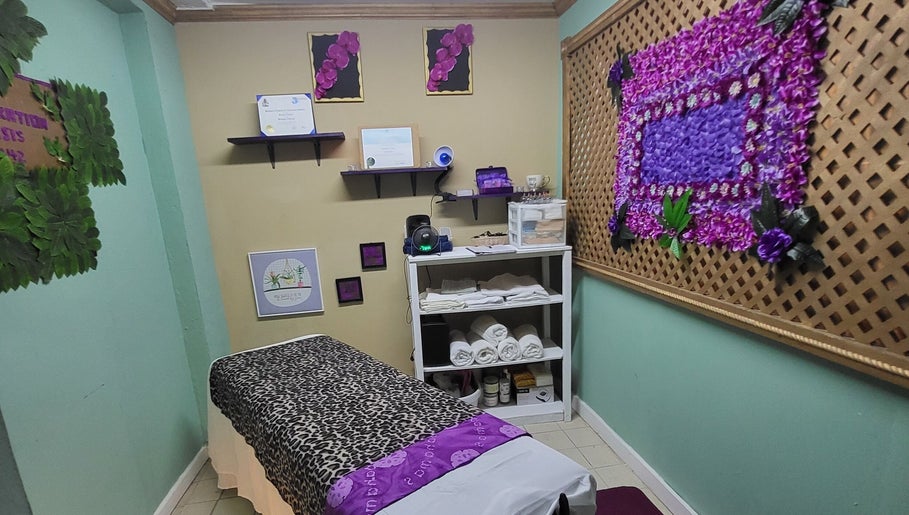 Relaxing treatment room at Lotus Relaxation Oasis 242, Nassau, New Providence, BS, with decorative floral accents.