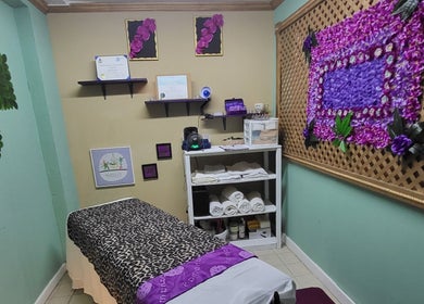 Relaxing treatment room at Lotus Relaxation Oasis 242, Nassau, New Providence, BS, with decorative floral accents.