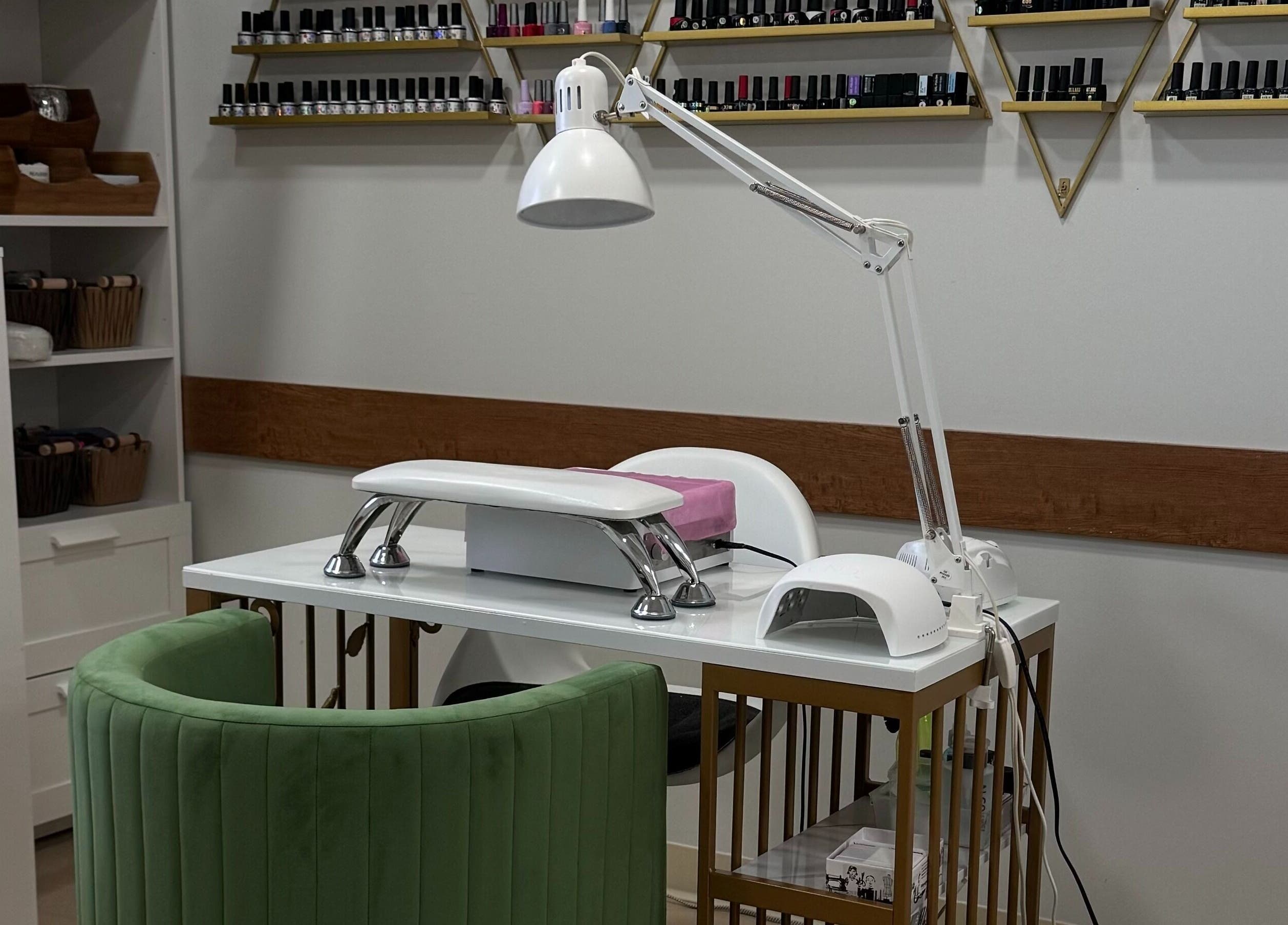 Luxurious nail station at Krystel MediSpa & Salon in Dieppe, New Brunswick, CA with stylish green chair.