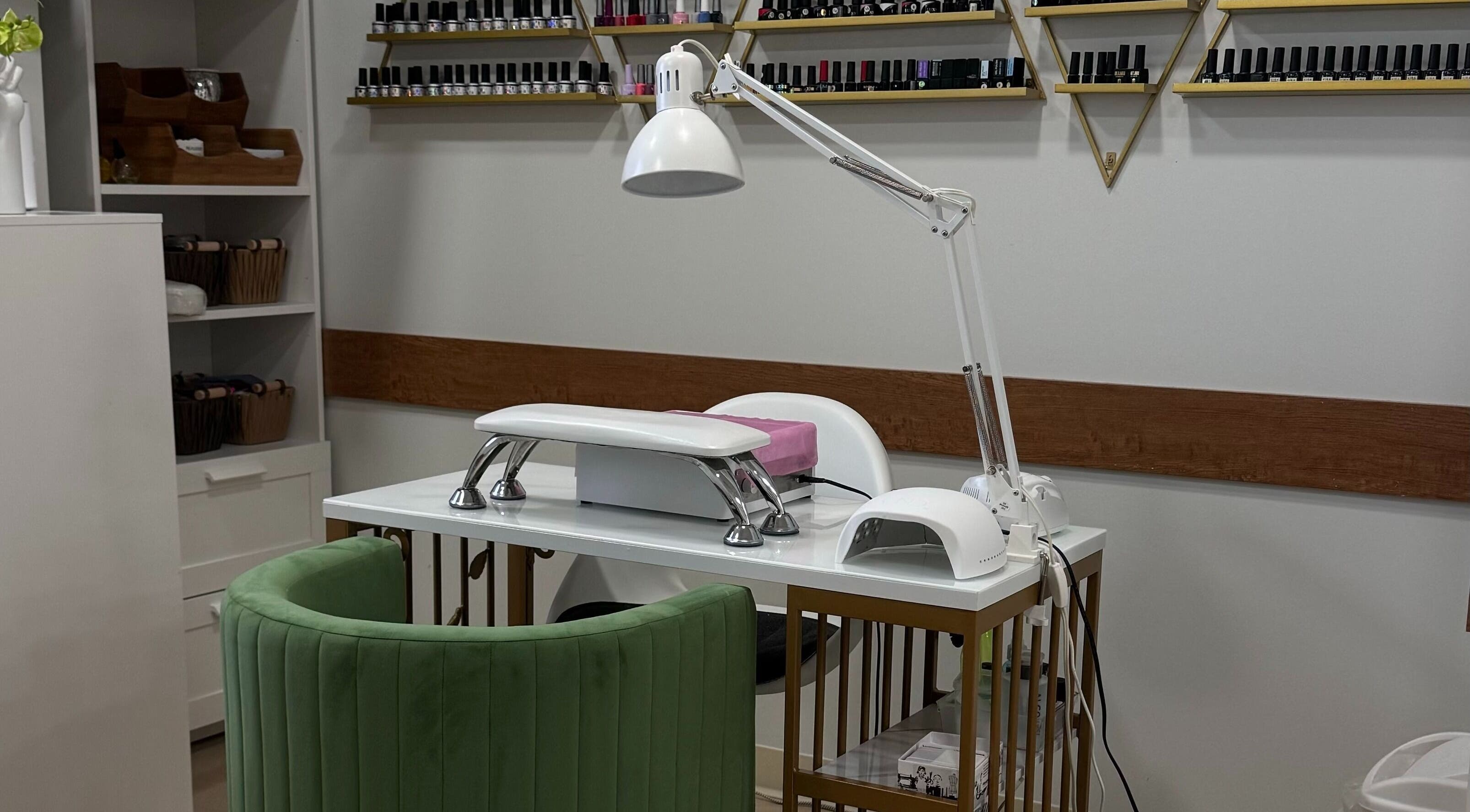 Luxurious nail station at Krystel MediSpa & Salon in Dieppe, New Brunswick, CA with stylish green chair.