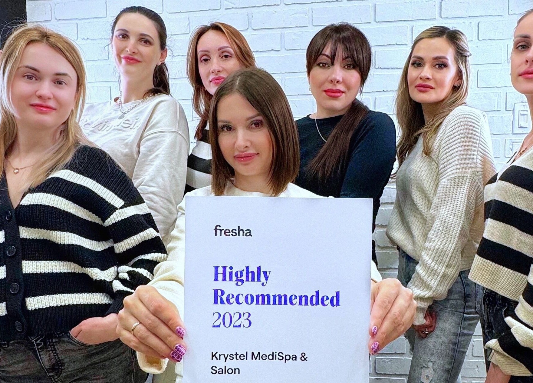 Krystel MediSpa & Salon team in Dieppe, New Brunswick, CA, proudly holding a 2023 Highly Recommended certificate.