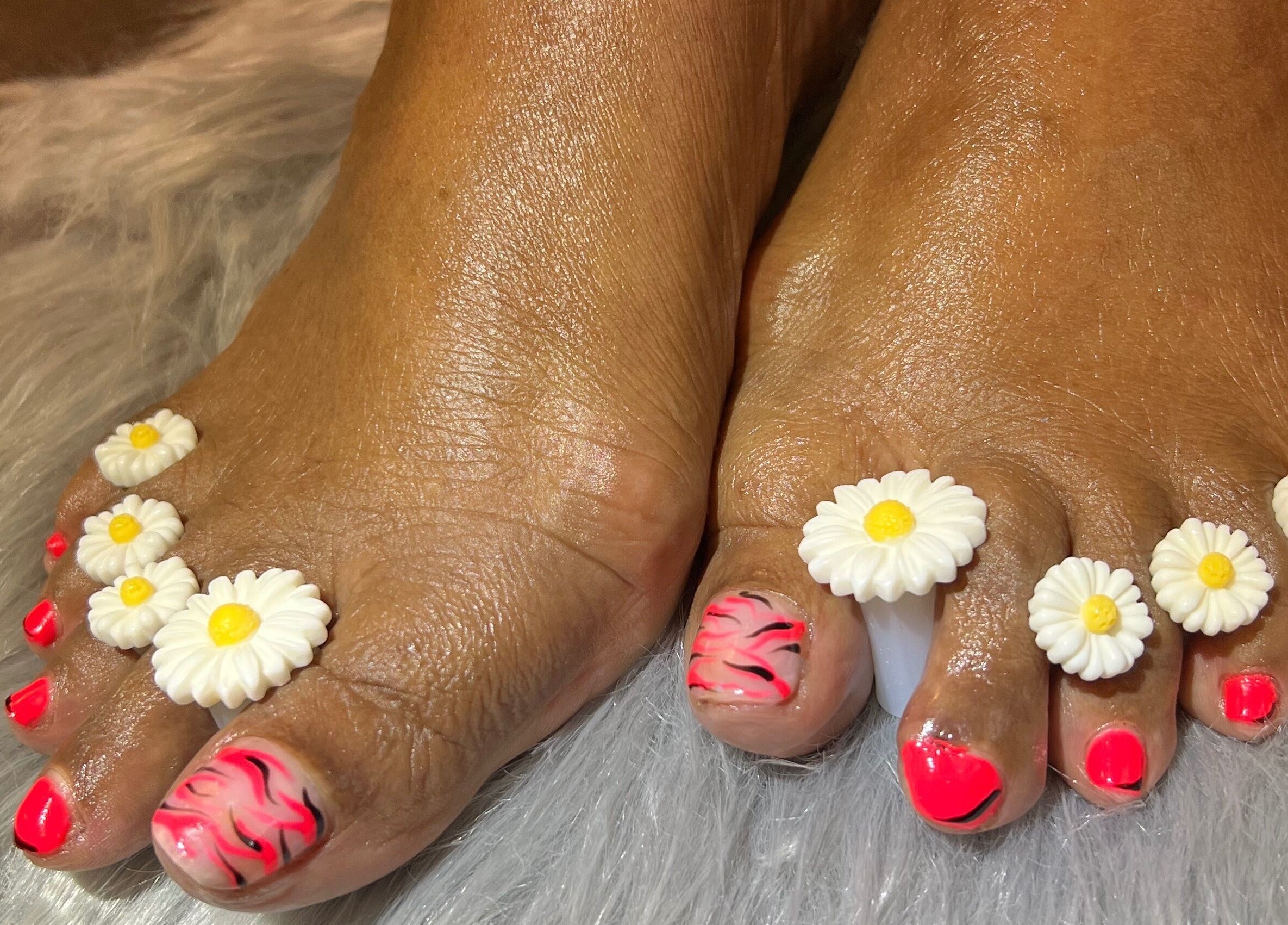 Bright floral pedicure at Nail Anatomy - Mobile, Stockbridge, Georgia, US. Vibrant nails with flower accents.