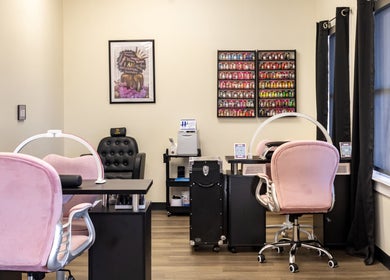 Chic nail salon interior at Nail Anatomy - Morrow in Morrow, Georgia, US featuring pink chairs and nail polish display.