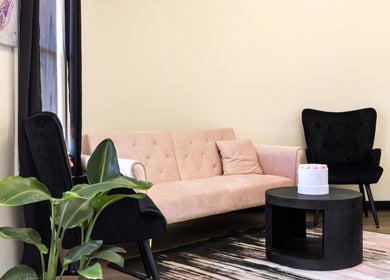 Elegant lounge area at Nail Anatomy - Morrow, Morrow, Georgia, US featuring plush seating and green plants.