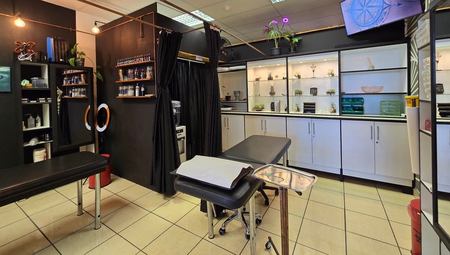 Interior of Assari Tattoo Studio, Johannesburg, Gauteng, ZA, showcasing professional tattoo workspace.