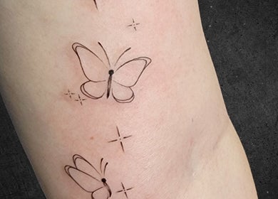 Elegant butterfly tattoos at Assari Tattoo Studio, Johannesburg, Gauteng, ZA, showcasing artistic ink design.