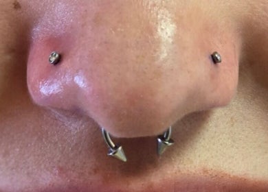 Intricate nose piercing at Assari Tattoo Studio, Johannesburg, Gauteng, ZA showcasing unique jewelry.