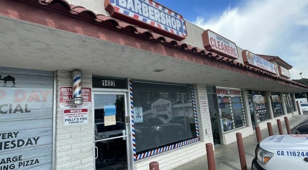 The Checkmate Barbershop entrance in Montebello, California, US, featuring a classic barbershop pole.