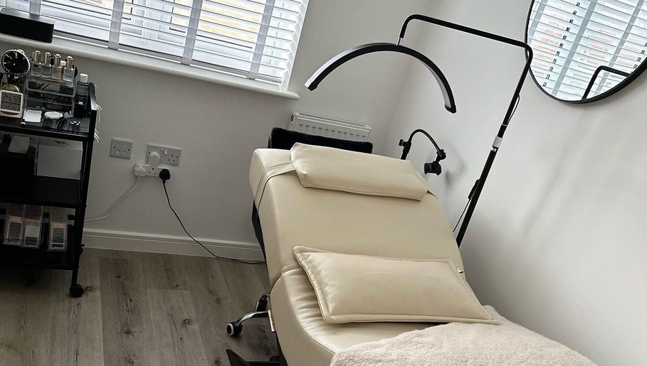 Luxurious treatment room at KK Beauty, Bedfordshire, England, GB, showcasing a comfortable therapy bed and modern decor.