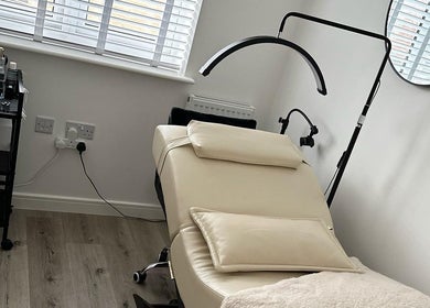 Luxurious treatment room at KK Beauty, Bedfordshire, England, GB, showcasing a comfortable therapy bed and modern decor.