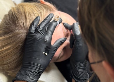 Beauty treatment in progress at KK Beauty, Bedfordshire, England, GB. Aesthetician applies precise treatment.