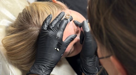 Beauty treatment in progress at KK Beauty, Bedfordshire, England, GB. Aesthetician applies precise treatment.