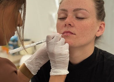 Expert lip treatment at KK Beauty, Bedfordshire, England, GB. Aesthetician applying precise care.