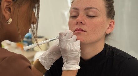 Expert lip treatment at KK Beauty, Bedfordshire, England, GB. Aesthetician applying precise care.