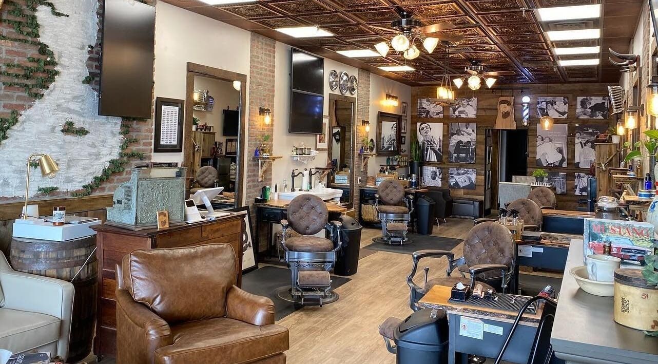 Spacious, vintage interior of Slik Barber Lounge, Florham Park, New Jersey, US, showcasing leather chairs and decor.