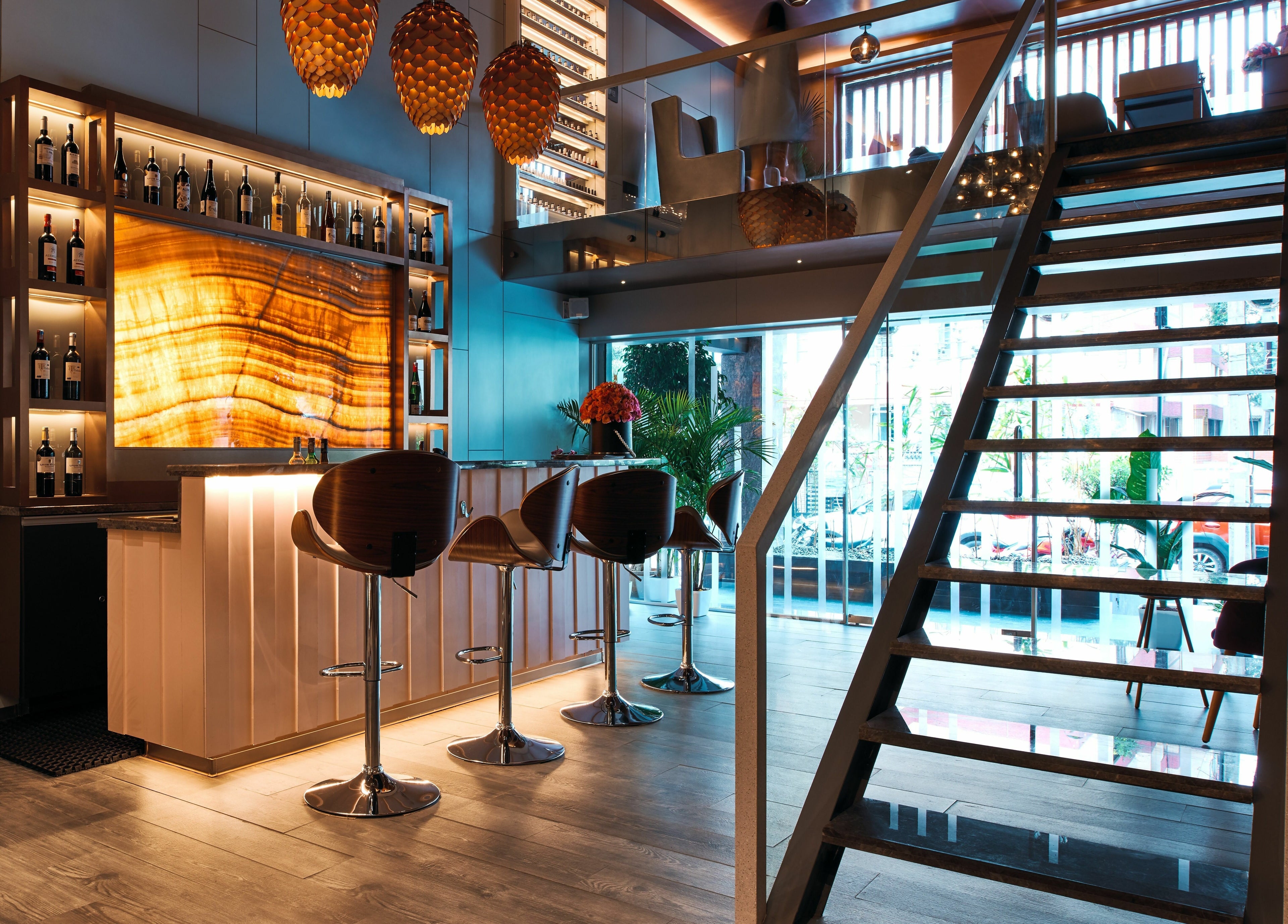 Stylish bar area at Blown - Salon - Vittal Mallya Road, Bangalore, Karnataka, IN with modern decor and seating.