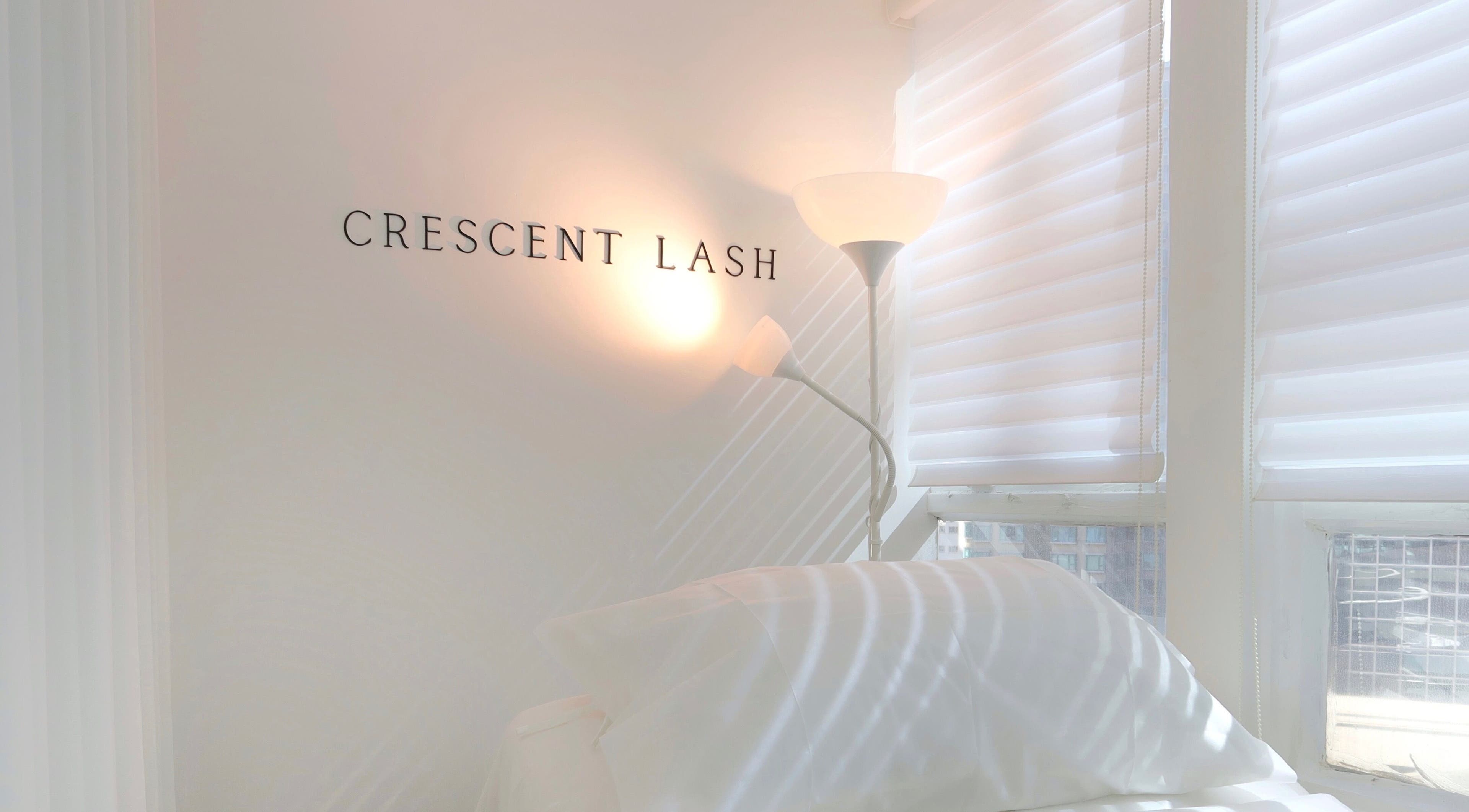 Cozy, well-lit interior of Crescent Lash on Hong Kong Island, HK, featuring soft white decor and natural light.